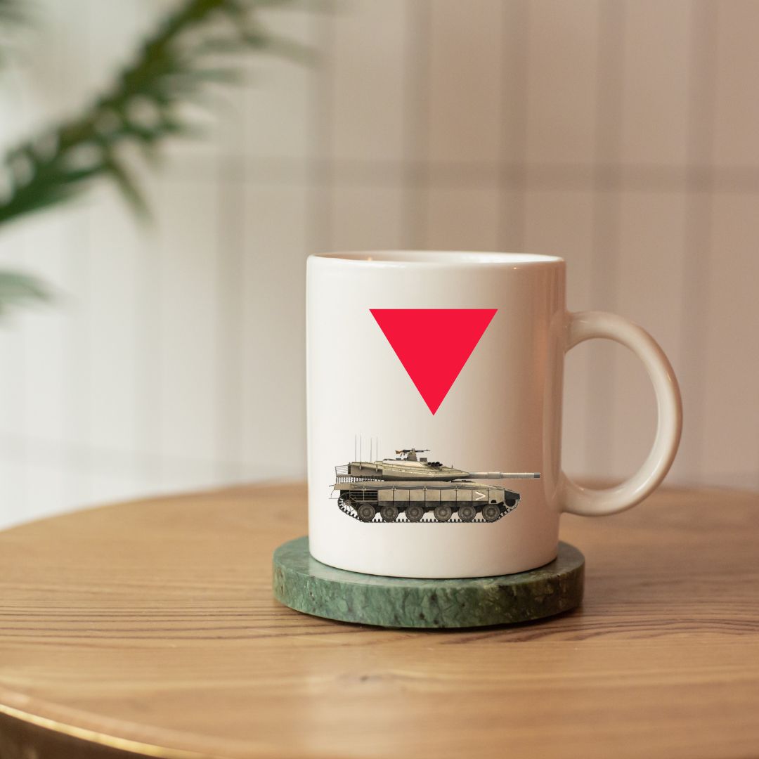 White mug with a red triangle and tankillustration on a wooden table